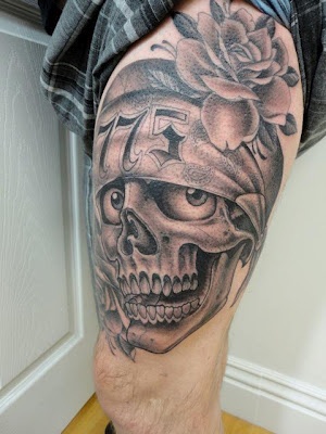 Rose and funny skull tattoo on leg