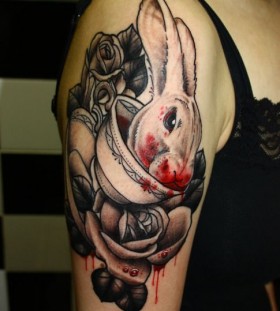 Rose, blood and rabbit tattoo on arm