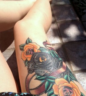 Rose flowers and camera tattoo on leg