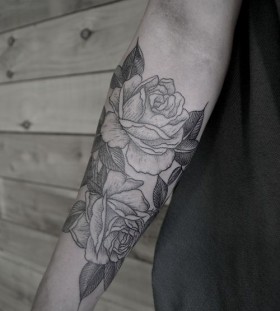 SImple black and white rose tattoo on arm
