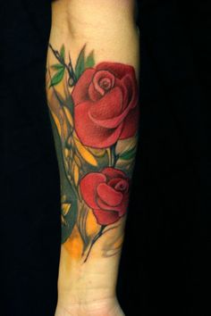 SImple red rose tattoo on arm