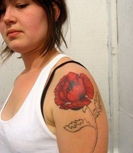Sad girl poppy tattoo on arm