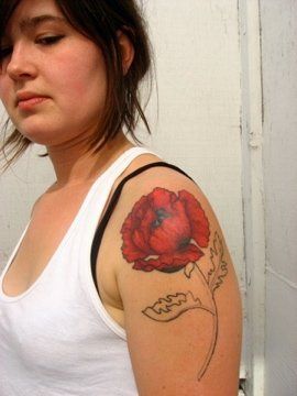 Sad girl poppy tattoo on arm