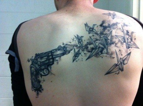 Scary gun and birds origami tattoo on shoulder