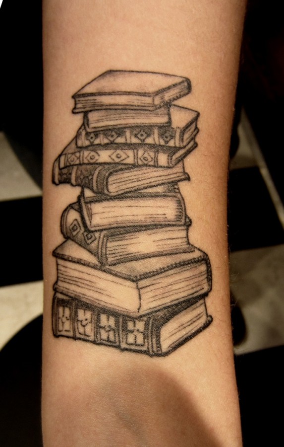 Science source book tattoo on arm