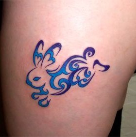 Scroll blue rabbit tattoo on arm