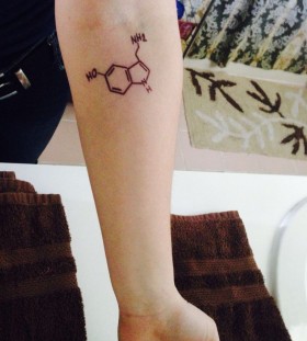 Serotonin tattoo on left arm