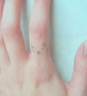 Simple angry cat tattoo on finger