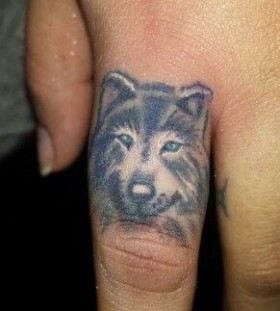 Simple black and white wolf tattoo on finger
