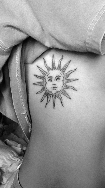 Simple black back sun tattoo