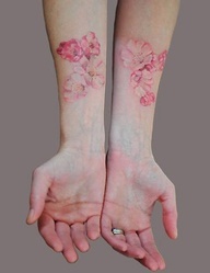 Simple red flowers watercolor tattoo