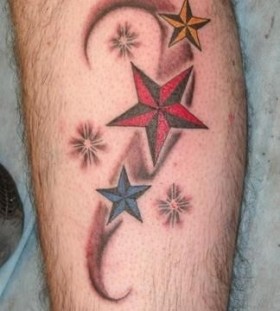 Simple red green blue star tattoo on leg