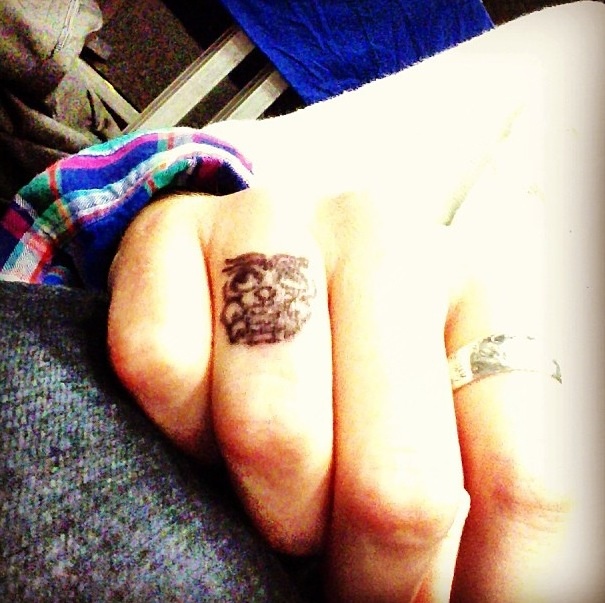 Simple women tattoo on finger