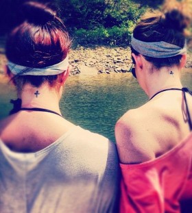 Sisters black back cross tattoo