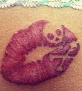 Skull and lips tattoo on arm