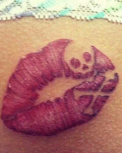 Skull and lips tattoo on arm