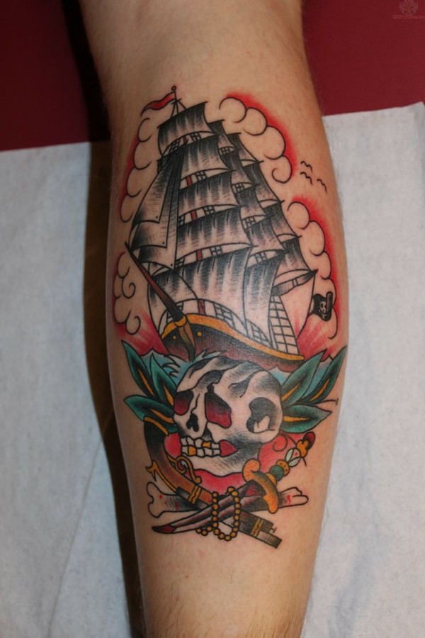 Skull and lovely ship tattoo on leg