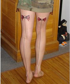 Skull bow and line tattoo on leg
