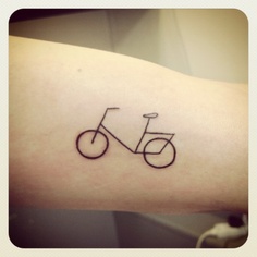 Small bicycle tattoo on arm