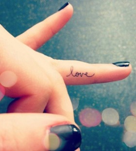 Small finger love tattoo on arm