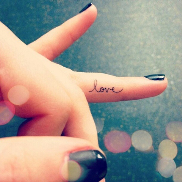 Small finger love tattoo on arm