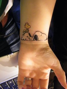 Snoopy tattoo on wrist