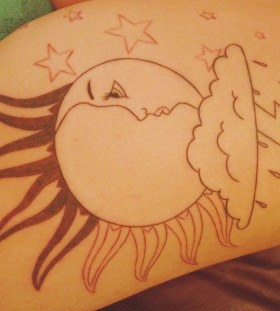 Star, moon and sun tattoo on leg