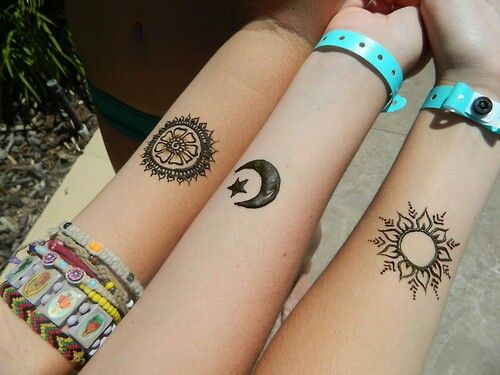 Stars, sun and moon tattoo on arm
