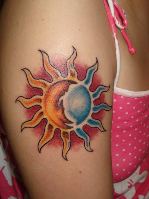 Stylish colorful sun tattoo on arm