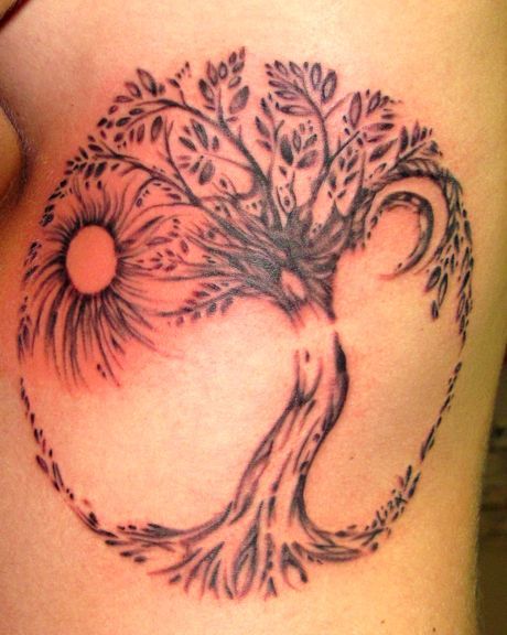 Sun and owal tree tattoo on leg