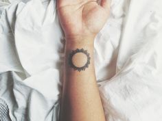 Sun tattoo on wrist