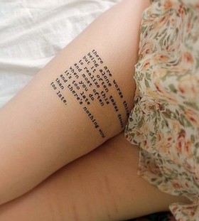 Times new roman style quote tattoo on leg