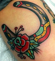 Traditional style horse shoe tattoo
