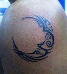 Tribal black moon tattoo on shoulder