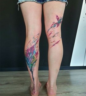 Watercolor tree and bird tattoo on leg