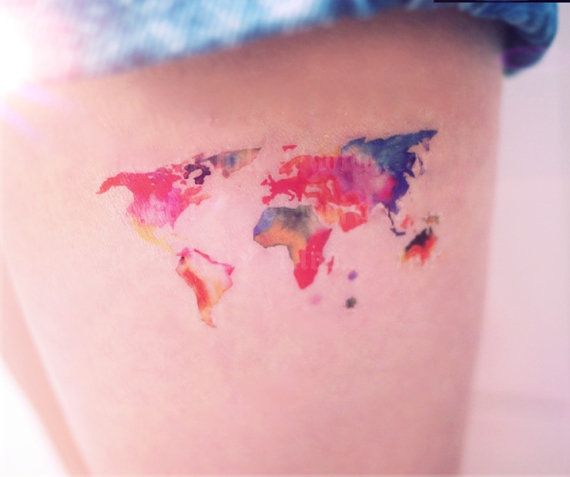 Watercolor world map tattoo on legs