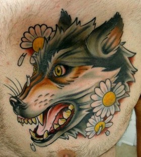 White flowers and wolf tattoo on arm
