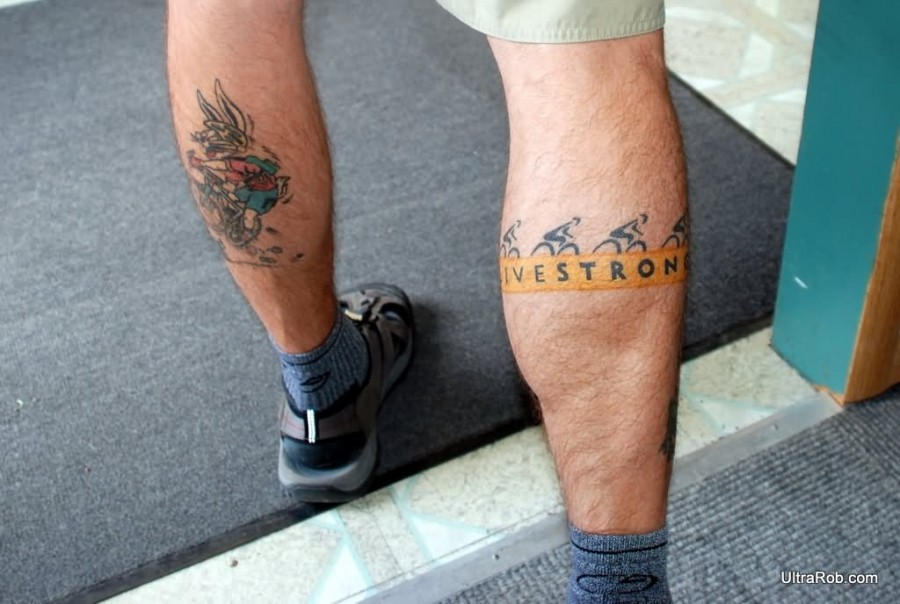 White wings and bicycle tattoo on leg