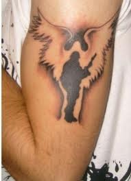 Wings and black soldier tattoo on arm