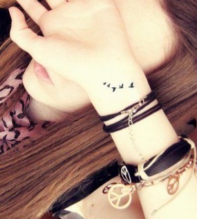 Woman wrist bird tattoo