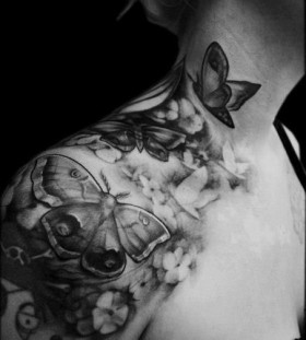 Women black and white shoulder butterfly tattoo on arm