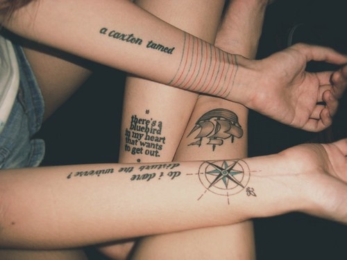 Women compass, quotes and map tattoo on legs