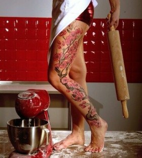 Women in kitchen and tree tattoo on leg