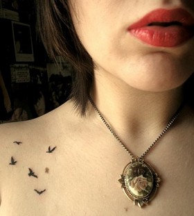 Women red lips, necklace and bird tattoo on shoulder