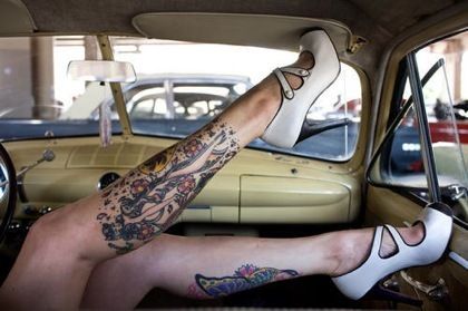 Women white high-heels and car tattoo on leg
