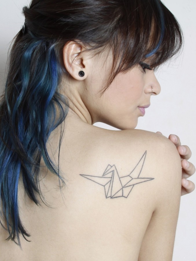 Women with blue hair origami tattoo on shoulder