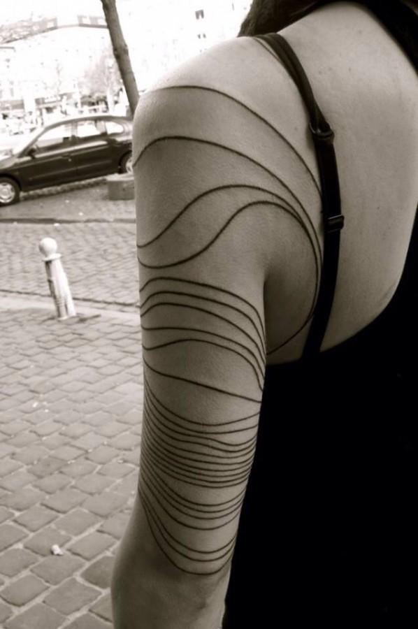 Women’s black line tattoo on arm