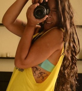 Women's camera and map tattoo on back