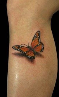 Yellow and black butterfly tattoo on leg