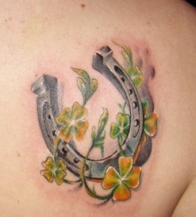 Yellow and green flowers with horse shoe tattoo